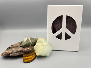 All natural plant based soap scented with nag champa and housed in a white box with a peace sign cut out surrounded by driftwood and crystals.