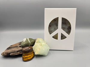 All natural plant based soap scented with  lavender essential oil and filled with organic lavender buds and housed in a white box with a peace sign cut out surrounded by driftwood and crystals.