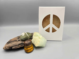 All natural plant based soap scented with patchouli essential oils and housed in a white box with a peace sign cut out surrounded by driftwood and crystals.